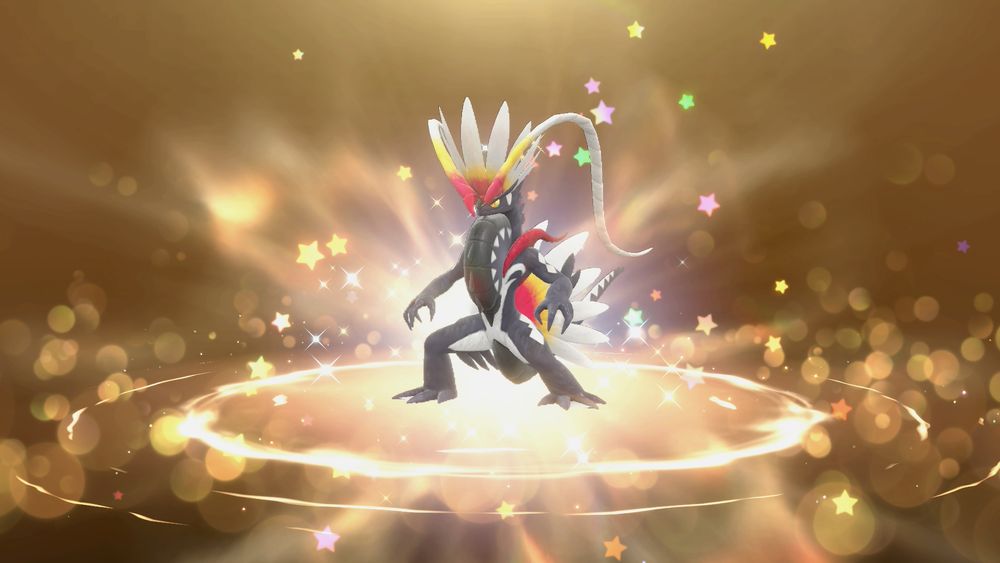 A golden background with a charcoal black bipedal lizard Pokémon surrounded by stars and sparkles.

The lizard Pokémon has red, yellow, and white head feathers, and large spiked chest piece.