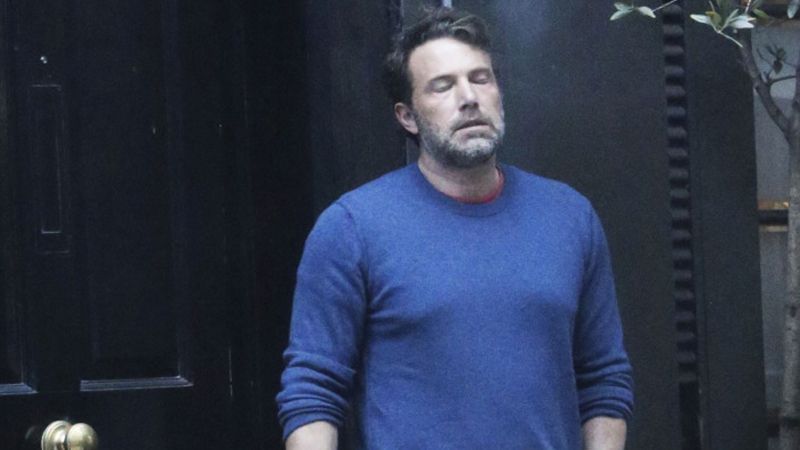 A paparazzi photograph of actor Ben Affleck smoking a cigarette with a distressed look on his face wearing a blue sweater that's a pretty good metaphor for my mood today. 