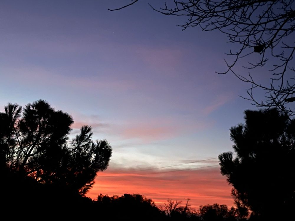 This morning’s sunrise slightly enlarged so that you could get a better shot of the drama that’s going on on the horizon