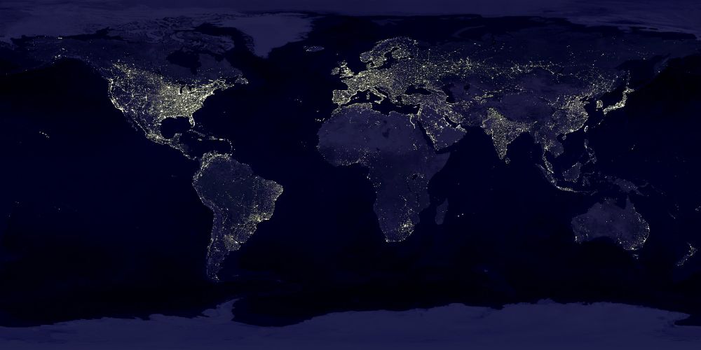This image of Earth’s city lights was created with data from the Defense Meteorological Satellite Program (DMSP) Operational Linescan System (OLS). Originally designed to view clouds by moonlight, the OLS is also used to map the locations of permanent lights on the Earth’s surface. The brightest areas of the Earth are the most urbanized, but not necessarily the most populated. (Compare western Europe with China and India.) Cities tend to grow along coastlines and transportation networks. Even without the underlying map, the outlines of many continents would still be visible. The United States interstate highway system appears as a lattice connecting the brighter dots of city centers. In Russia, the Trans-Siberian railroad is a thin line stretching from Moscow through the center of Asia to Vladivostok. The Nile River, from the Aswan Dam to the Mediterranean Sea, is another bright thread through an otherwise dark region. Even more than 100 years after the invention of the electric light, some regions remain thinly populated and unlit. Antarctica is entirely dark. The interior jungles of Africa and South America are mostly dark, but lights are beginning to appear there. Deserts in Africa, Arabia, Australia, Mongolia, and the United States are poorly lit as well (except along the coast), along with the boreal forests of Canada and Russia, and the great mountains of the Himalaya.