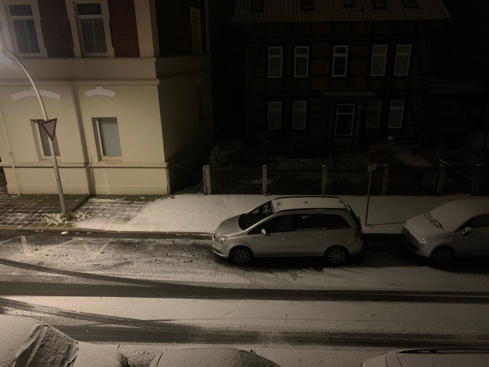 Cars parking on a snow covered street 