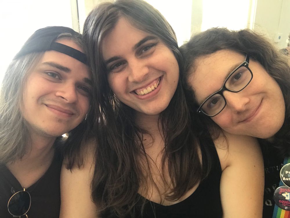 Girlfriend with backwards cap and sunglasses on the left, girlfriend w glasses and curly hair on the right