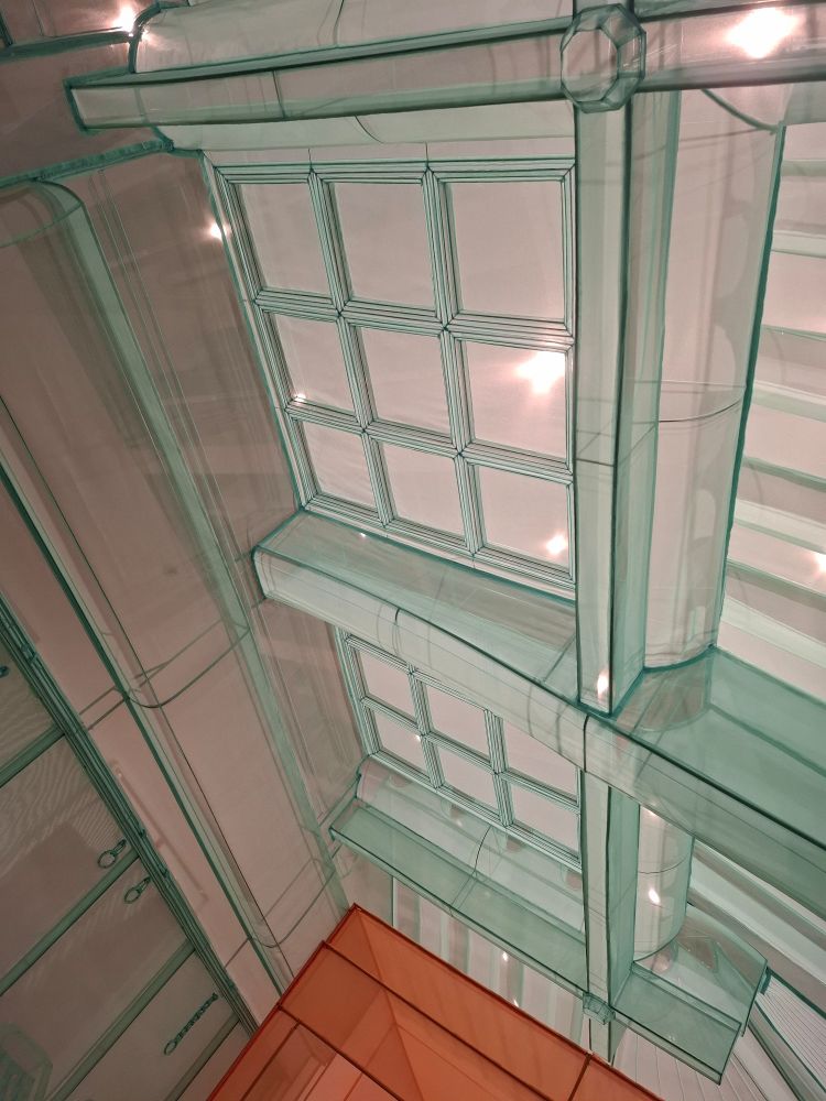 An interior ceiling made from lightweight, transparent sea foam coloured fabric and wire. There are intersecting beams and a multipanelled skylight. Part of Do Ho Suh's Walk the House exhibition at Tate Modern.