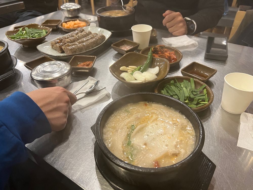 a bowl of dwaejigukbap and a plate of sundae