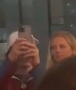 a woman in the audience looking askance 