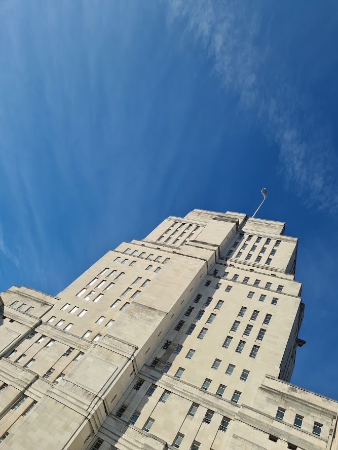 Image of the Senate House building, London set against a blue sky.