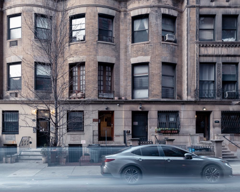 Car parked in front of row houses