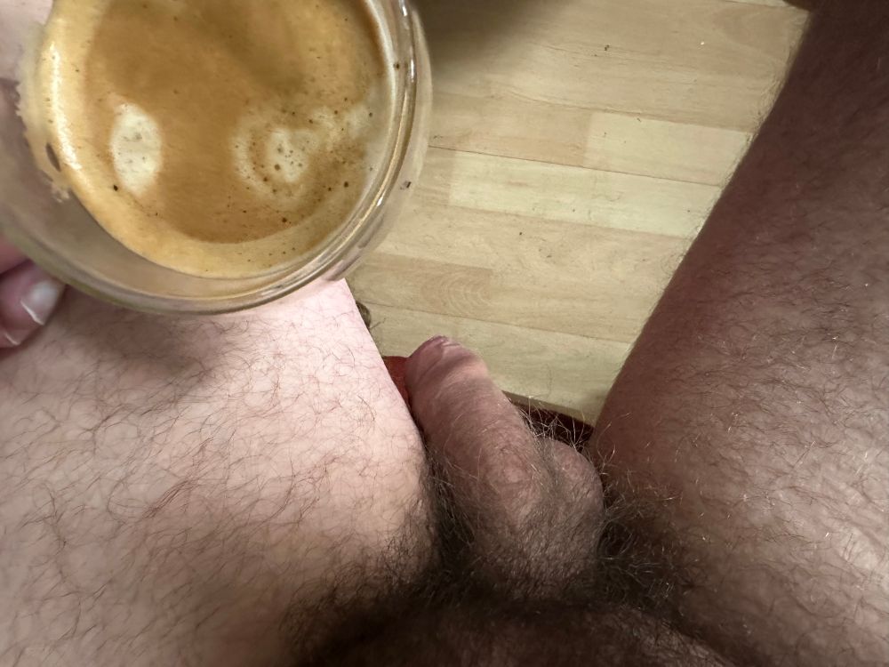 My soft cock between my thighs, with a cup of coffee 
