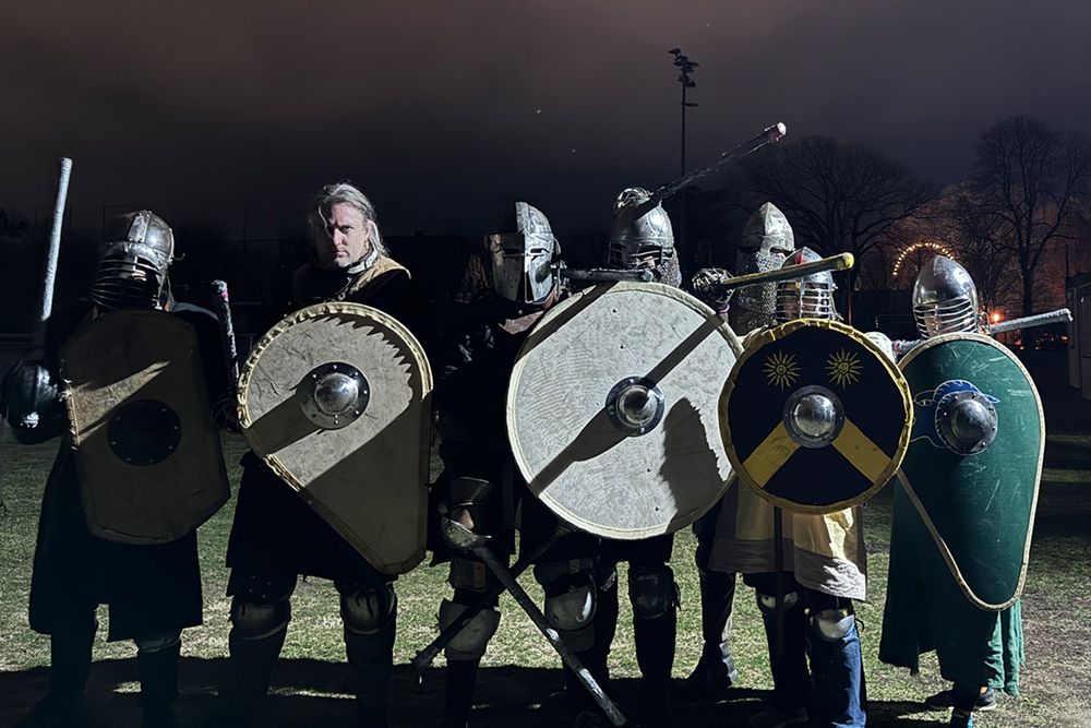 A group of early mediaval warriors with shields and swords