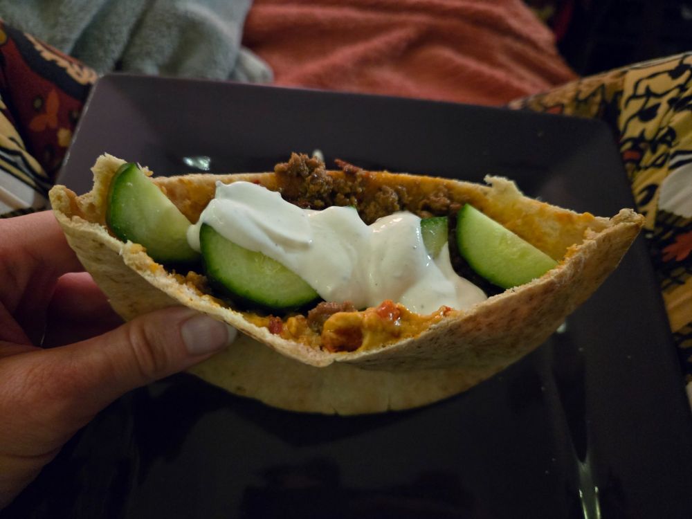 It's a pita, filled with hummus, leftover ground lamb that i cooked with onions, jalapeños and chipotles in adobo for tacos, with some chopped cucumber and leftover crema on top. 

