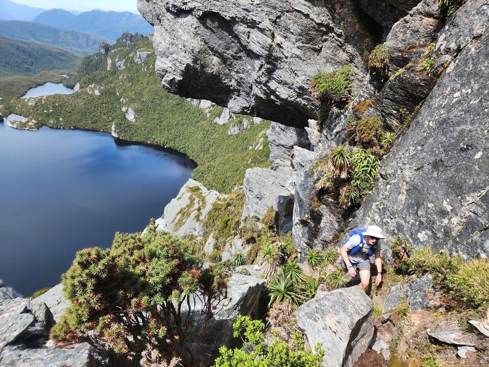Person walking under rock s on the western arthurs traverse