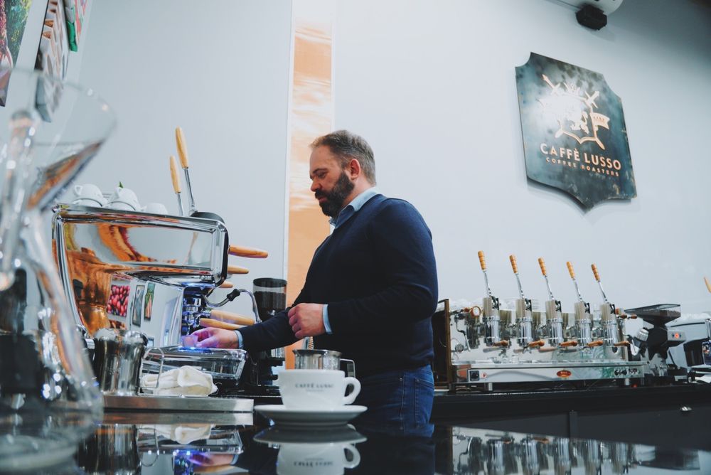 Philip Meech makes coffee at Caffe Lusso.