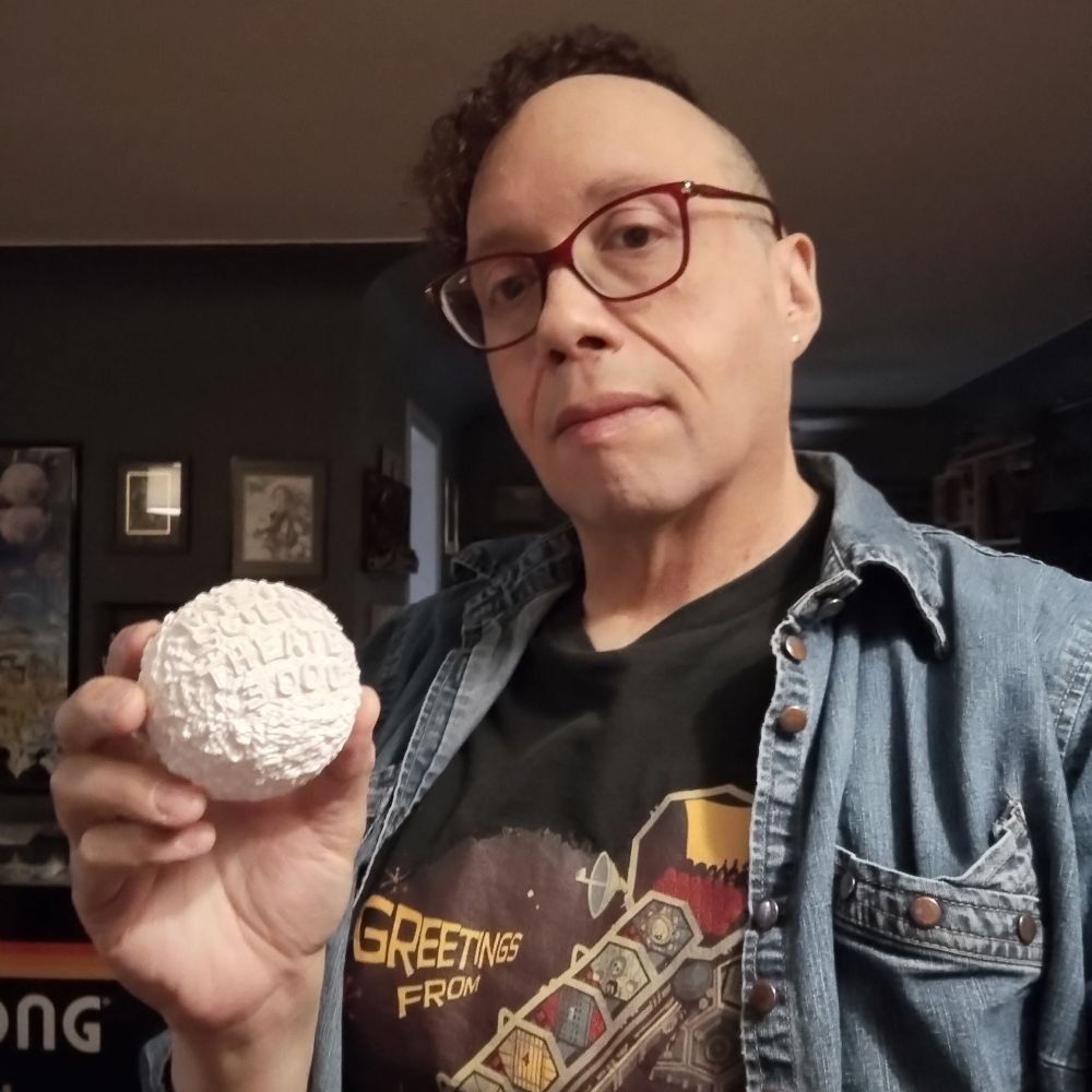 Here is a picture of my big noggin with hair that is slowly becoming more pliable in the sense that it is getting closer to what I want. In my hand is a 3D MST3K moon.