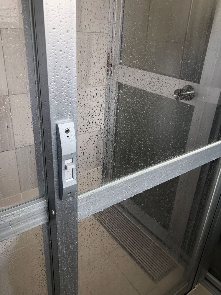 Glass shower door with a lock on the inside