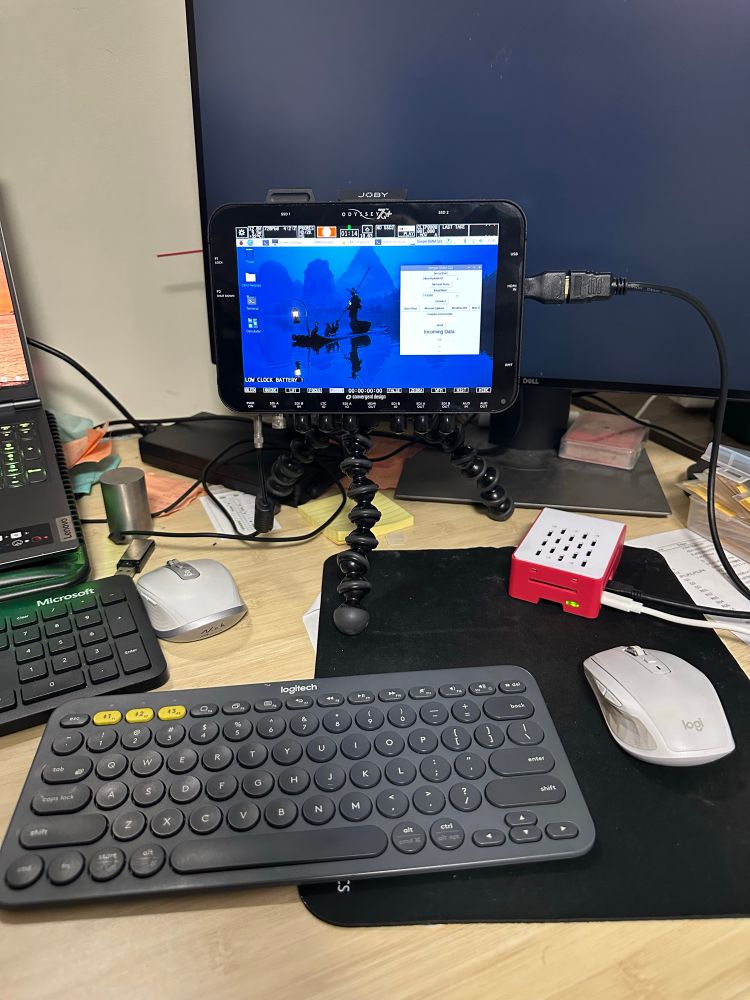 A Raspberry Pi in a case using a video production capture monitor as the display.