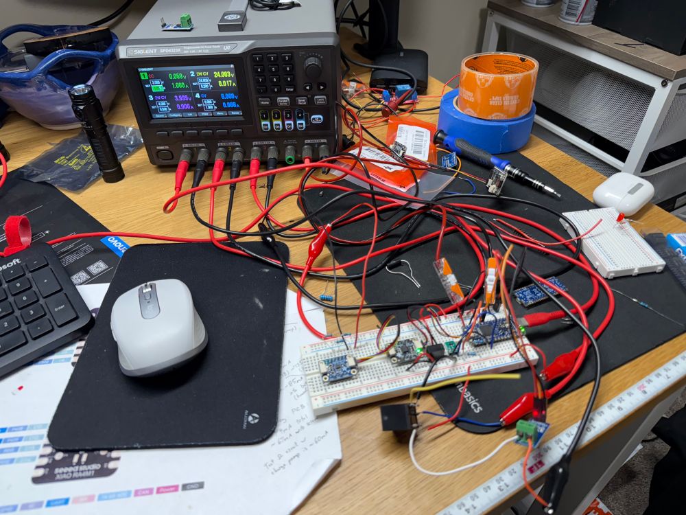A breadboard populated with an Arduino and various modules has four different voltage rails coming in off a power supply. 