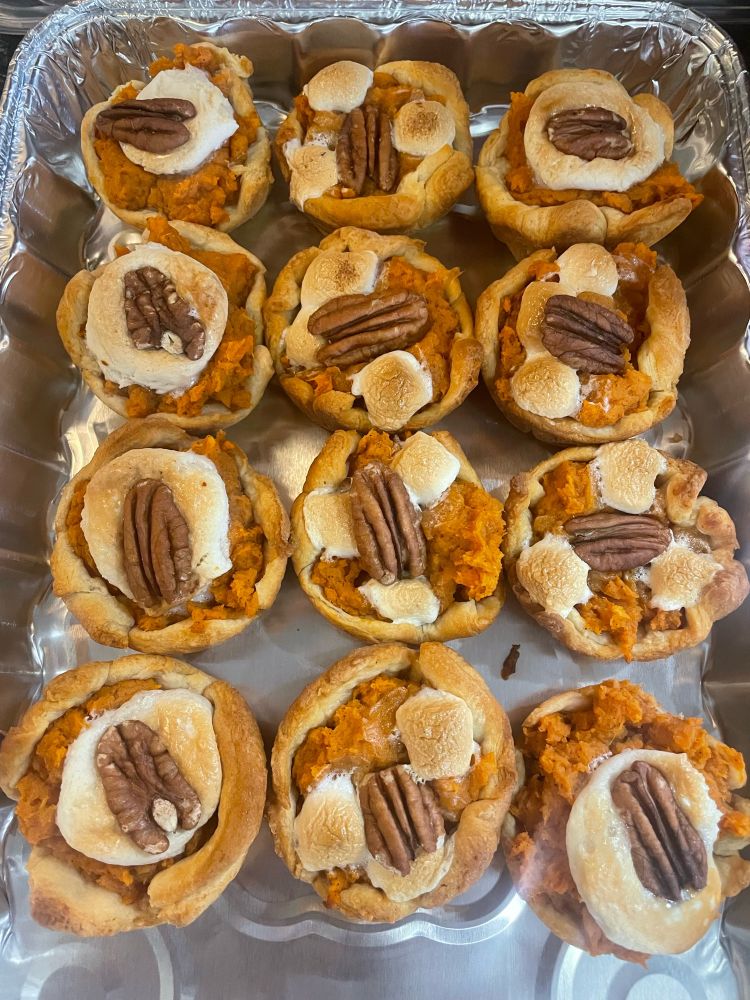 freshly baked sweet potato crescent rolls topped with marshmallows and pecans