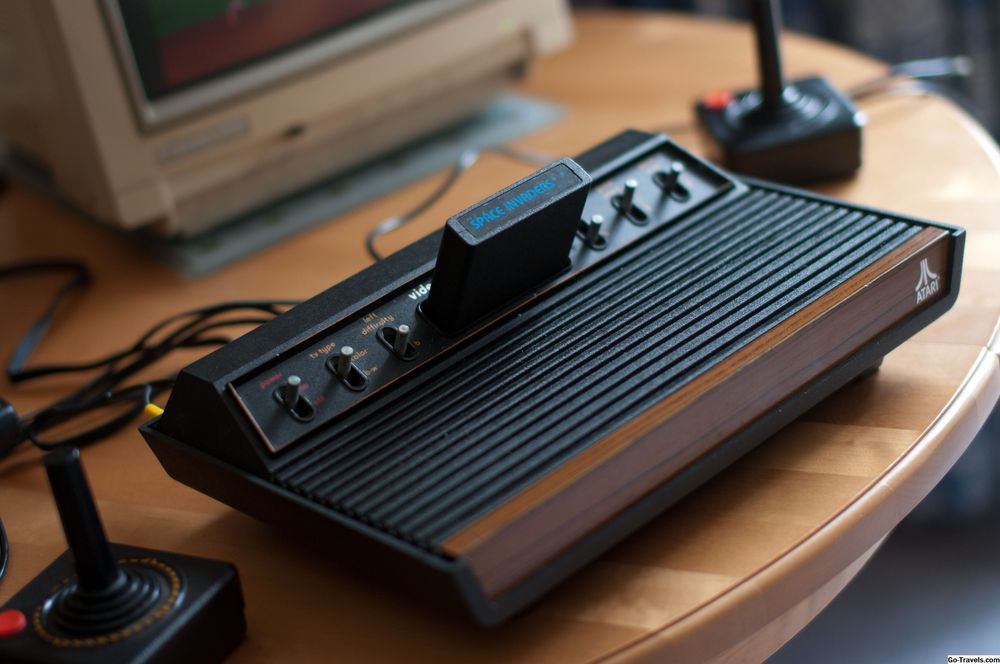 An original Atari 2600 gaming system with a Space Invader cartridge and 2 joysticks connected