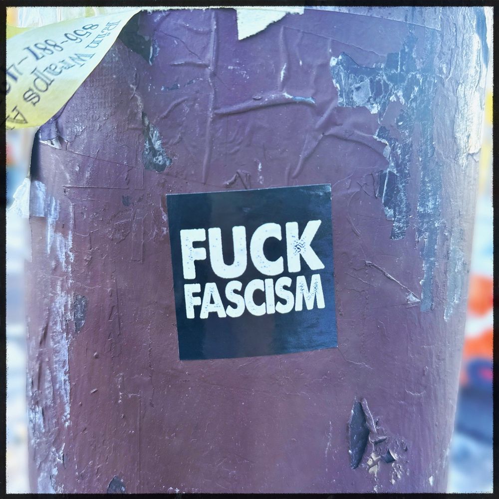 Sticker on a telephone poll that says Fuck Fascism 