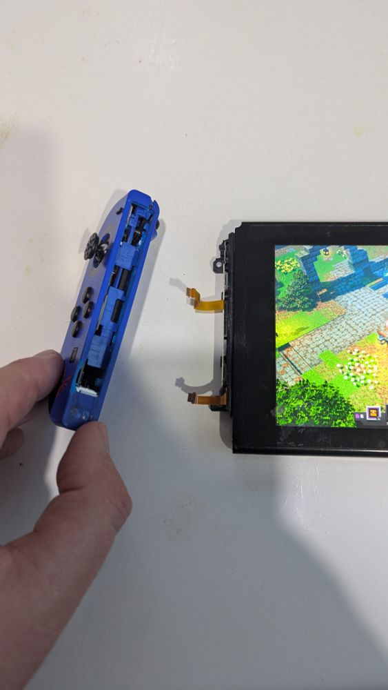 A Joy-Con unceremoniously detached from its Nintendo Switch. 