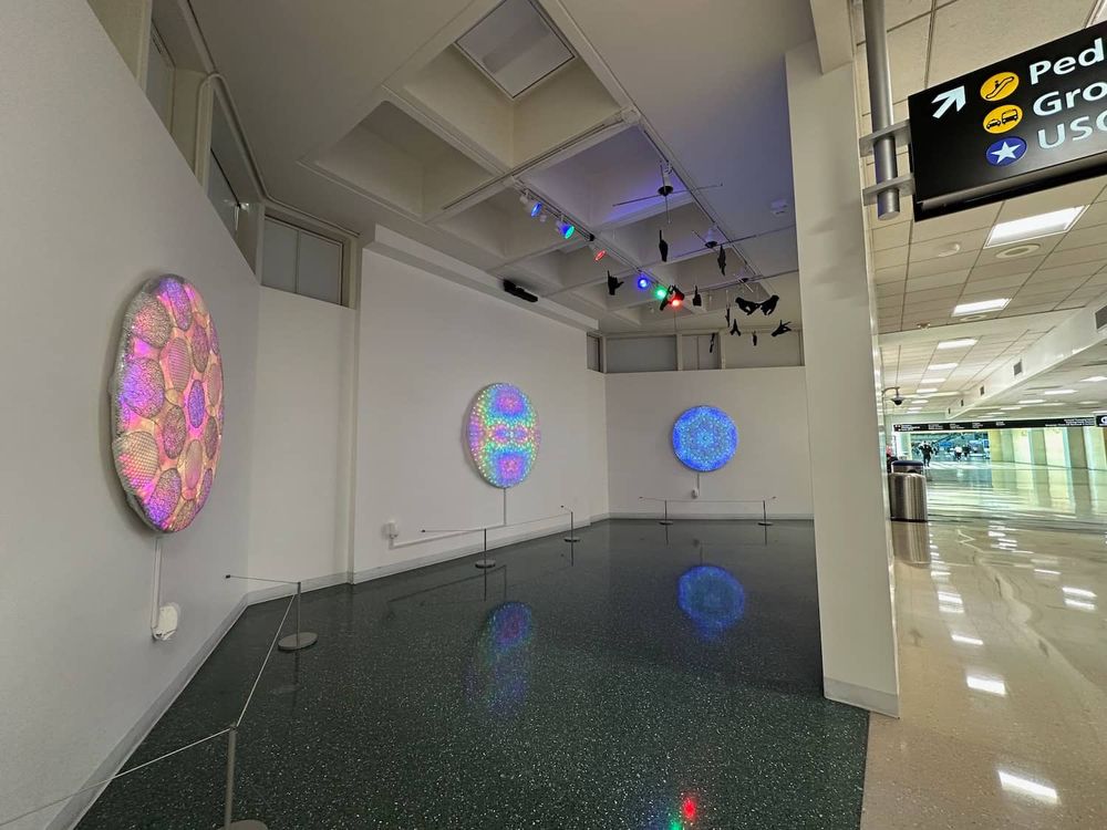 LED art panels (48" to 60" diameter) on display in airport gallery