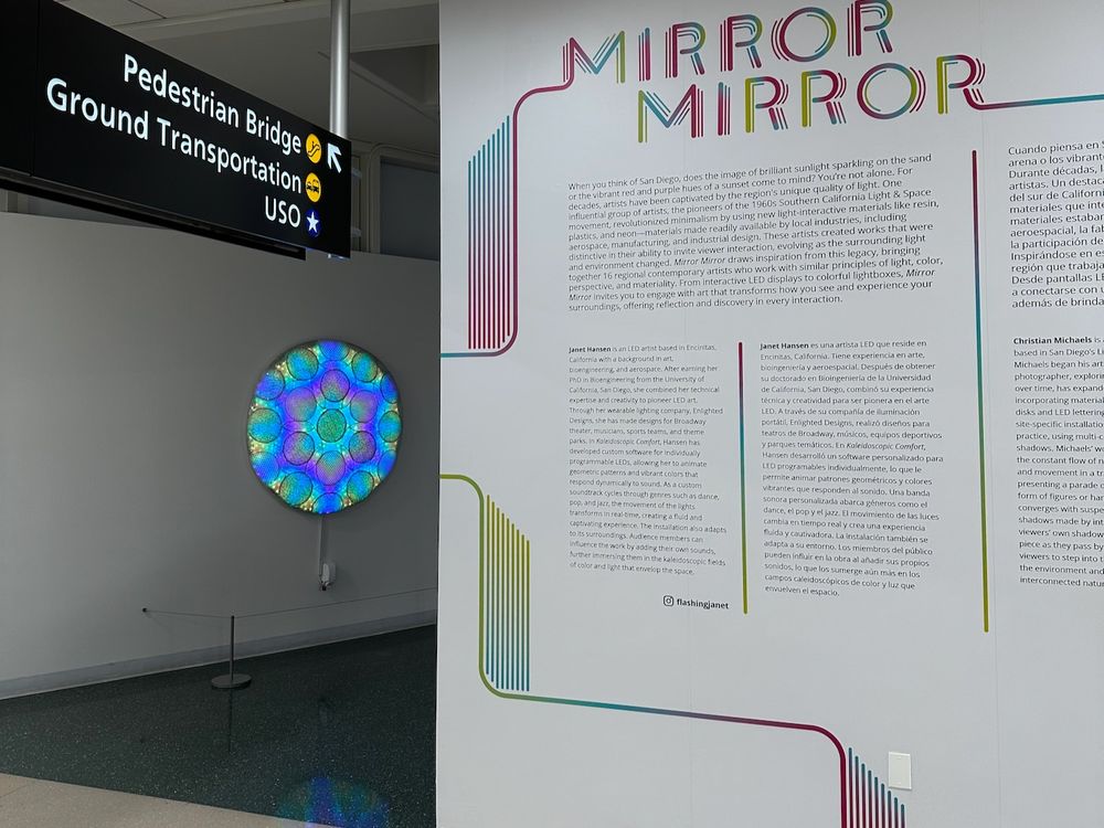 LED art installation, with lights embedded in round fabric panels, shown in airport hallway