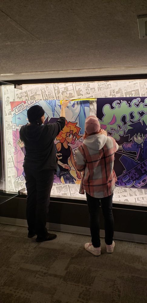 Me and an artist friend measuring the distance in order for the banners ro be placed correctly, but from the back