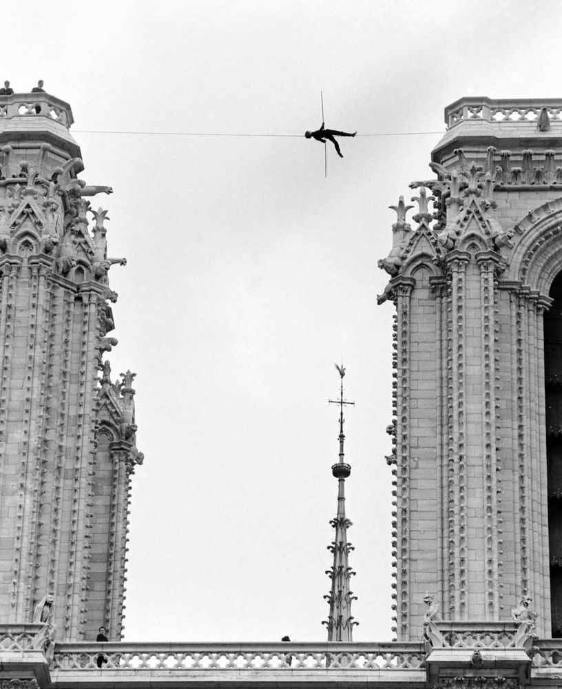 Philippe Petit lying down on high-wire walk above Notre Dame Cathedral in 1971.