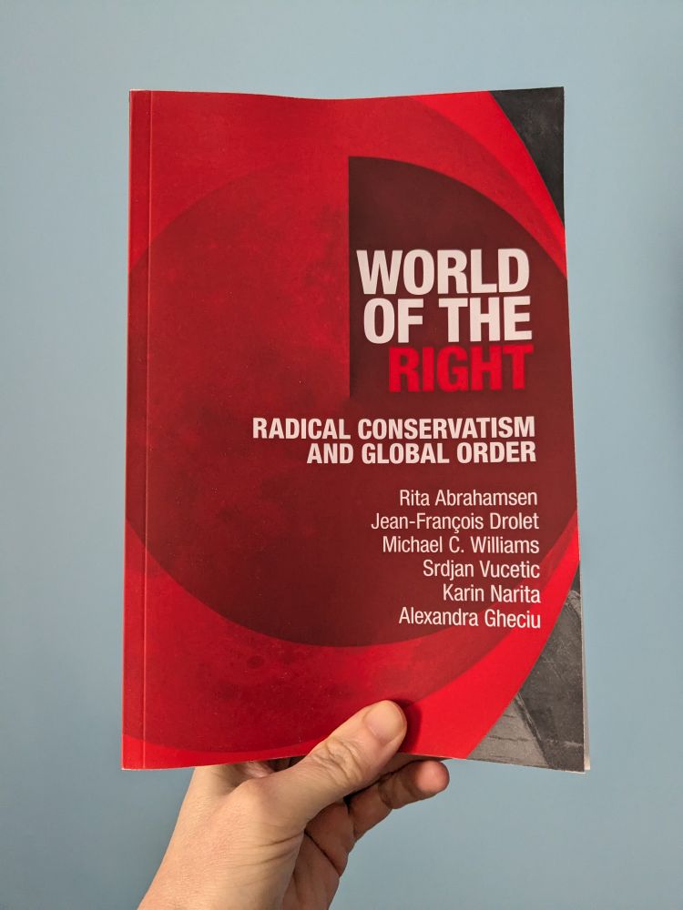 A paperback book with a cover in shades of red showing the title 'World of the Right: Radical Conservativism and Global Order' and the list of co-authors Rita Abrahamsen, Jean-François Drolet, Michael C. Williams, Srdjan Vucetic,  Karin Narita, Alexandra Gheciu. 