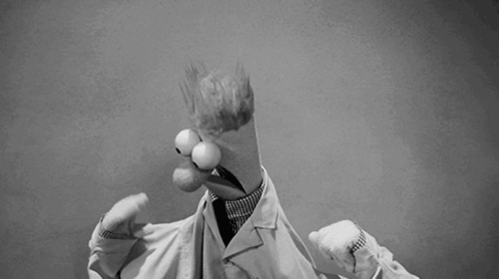 a black and white photo of a cartoon character in a lab coat and tie .