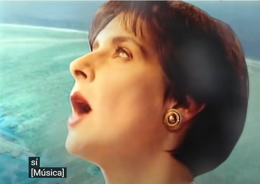 Enya in the video for her song Orinoco Flow.
the subtitles state si and [Musica] as they don't give us the lyrics