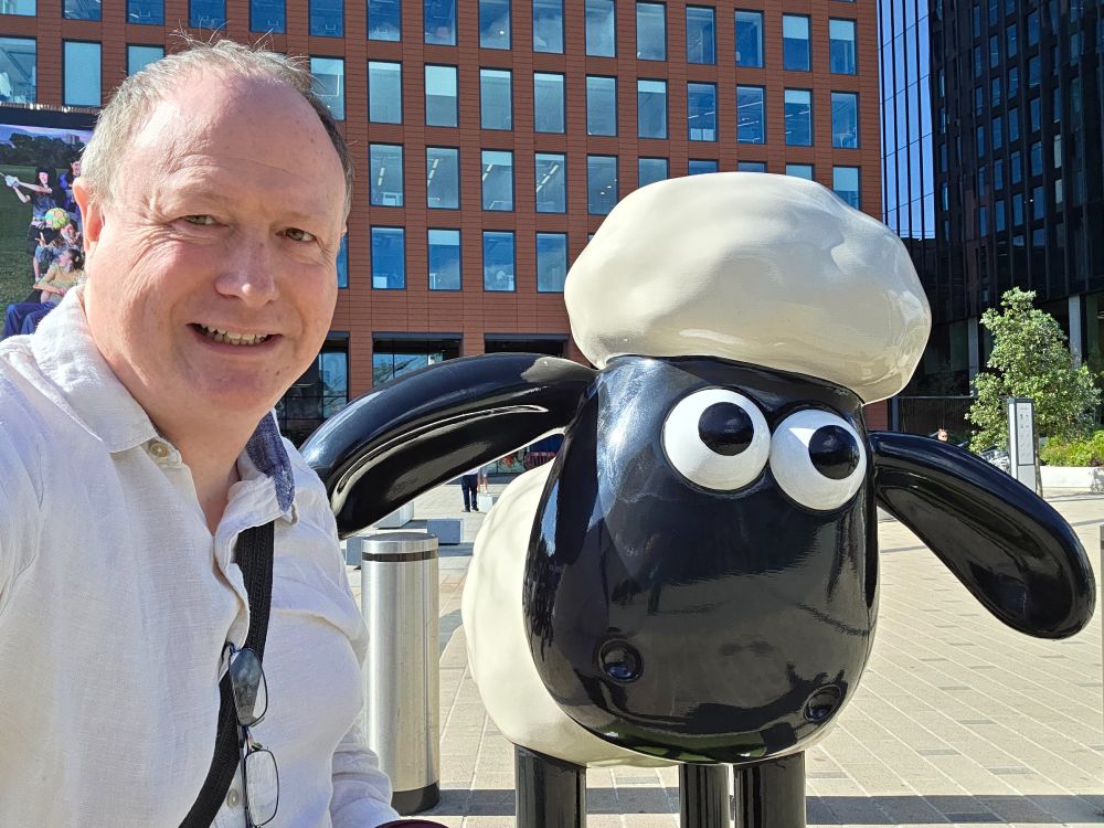 Phil Creighton next to a statue of Shaun the Sheep in Reading town centre