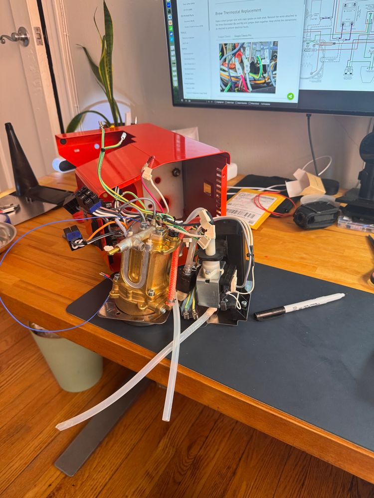 Espresso machine on its side with components removed