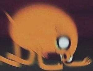 Blurred image of Jake the Dog on his knees bent to the ground screaming 