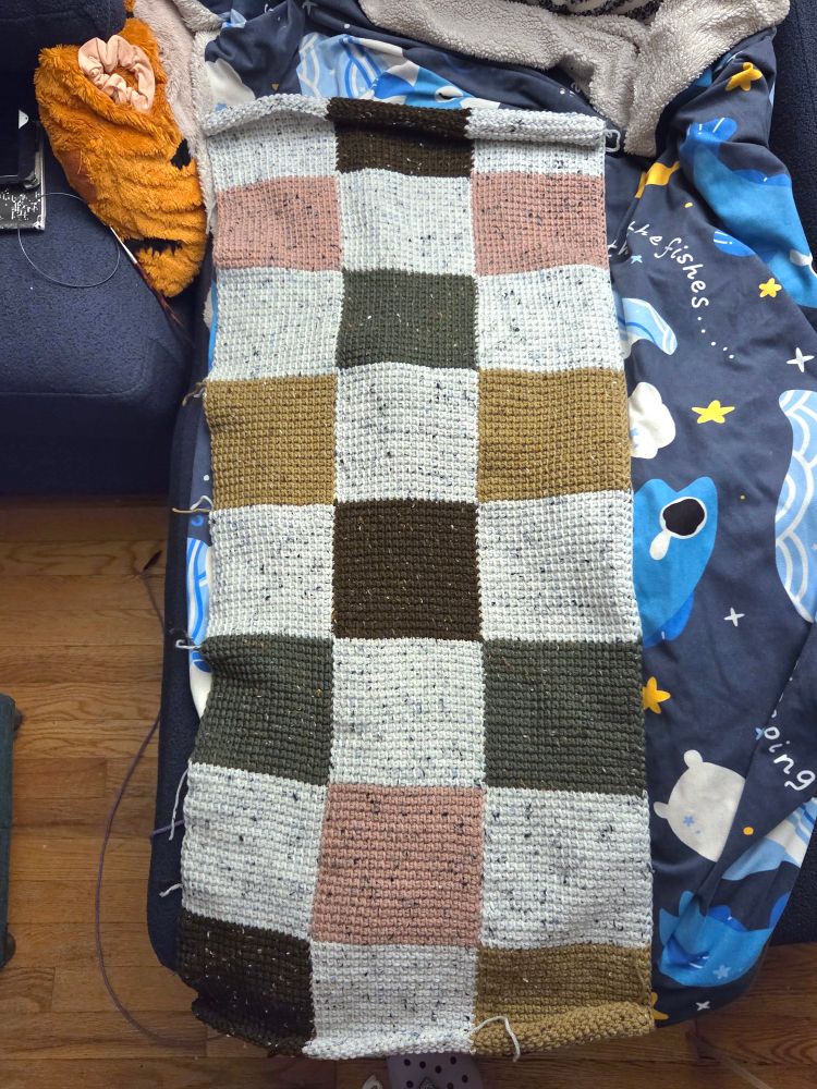 Overhead shot of a color blocked blanket, halfway finished