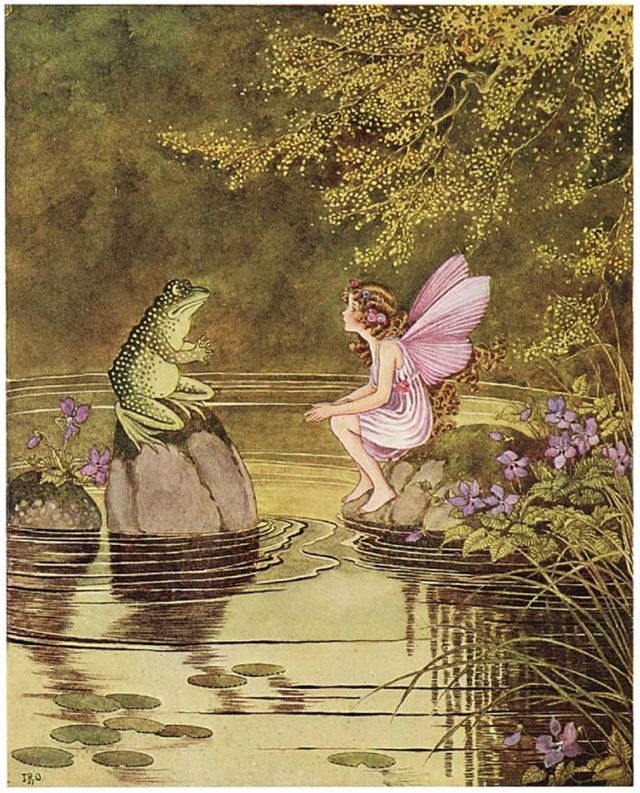 Colour illustration, 1922. A fairy and a frog sit on opposite rocks on a woodland pond, apparently having a chat. The scenery around them includes trees, grasses and flowers and there are lily pads on the water's surface. The fairy wears a pink dress and has pink wings.