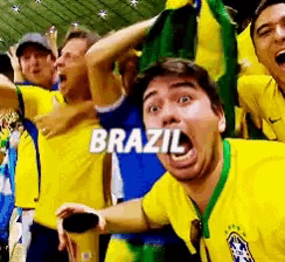 a man in a yellow shirt with the word brazil written on his face