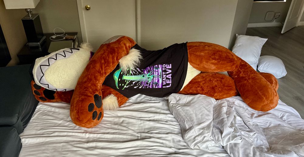 A 6-foot stuffed plush coyote from Creepcat wearing a tank top from Weasel Gear