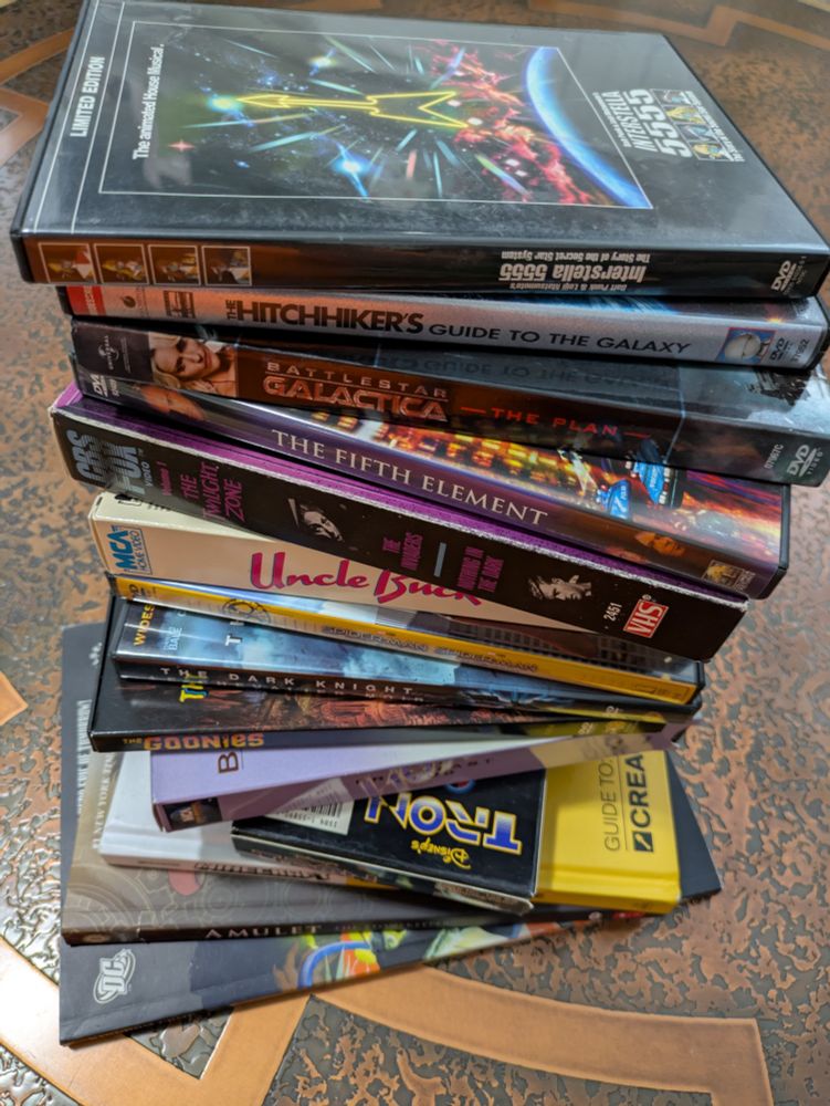 Variety of DVDs, VHS and books.