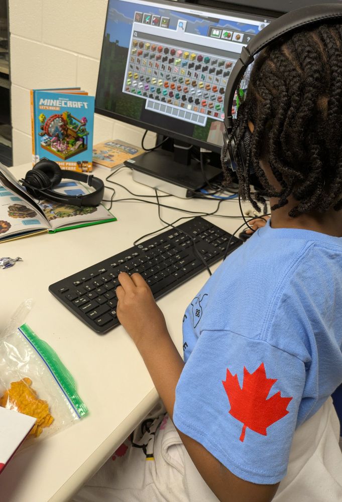 A Minecraft eSports squad member collaborating with her team on a build