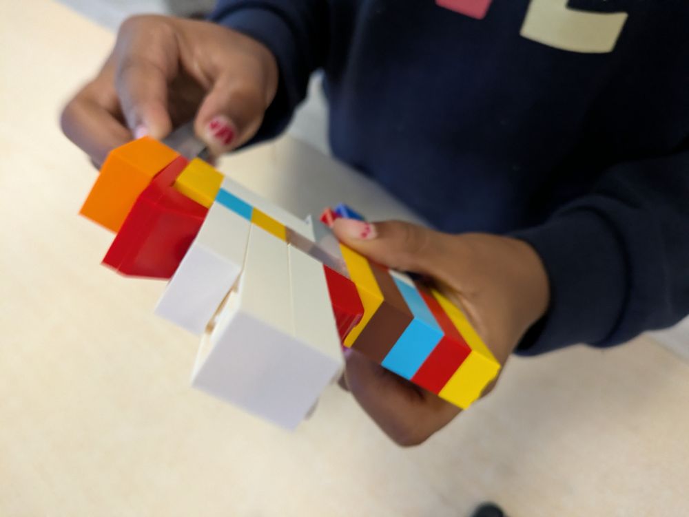 Grade 1 friend building their LEGO tower up & not giving up when it falls down 
