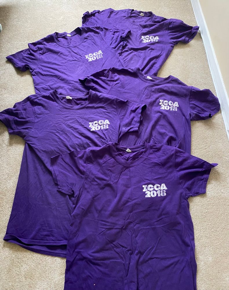 5 purple t shirts with the label “ICCA2018”