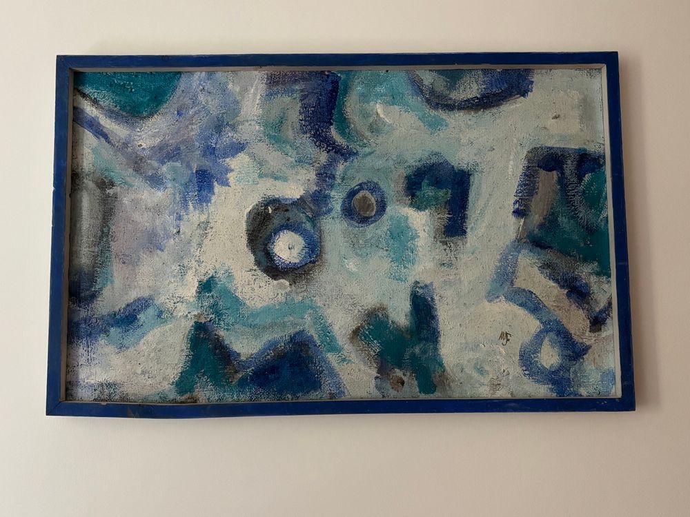 A swirly, abstract oil, painting, and shades of lighter blue and around a third white hanging on the wall 