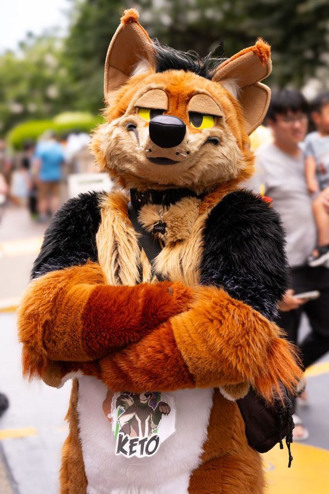 photo of garbanzo at the AC 2025 block party, arms crossed and looking very smug at the camera
