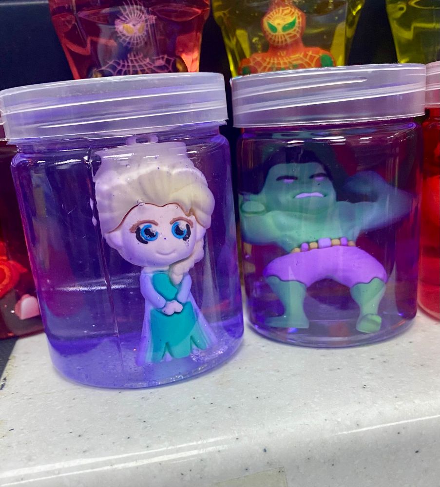 Terrifying jars filled with an unknown fluid with a sort of chibi Elsa and Hulk in them. 