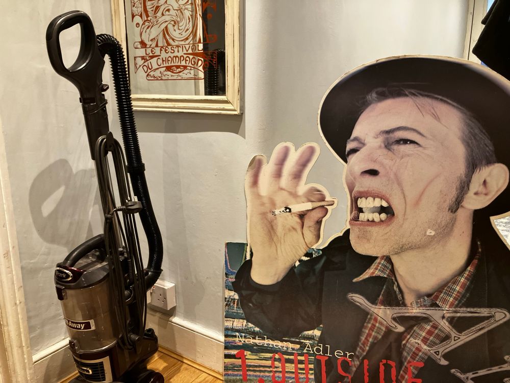 Giant cardboard stand of David Bowie as Nathan Adler, promoting the 1.Outside album. Looking at the hoover.