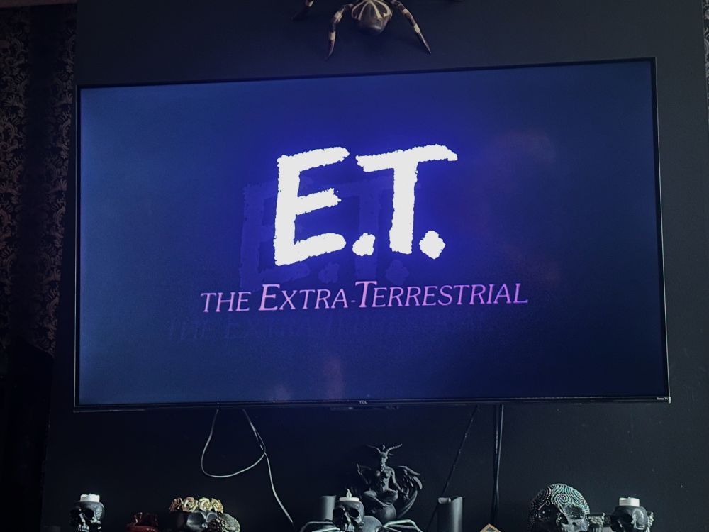 Tv screen showing white ET title on blue gradient background