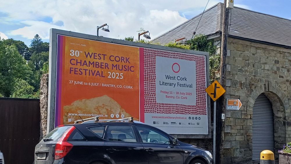 West Cork Chamber Music Festival and West Cork Literary Festival billboard on the way into the town of Innishannon in West Cork 
