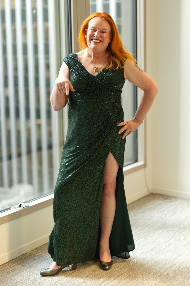 Me, in a sequined sleeveless dark green gown, split on the left to my hip.