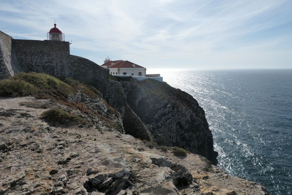 A lighthouse sits on the Cabo de São Vicente that juts out into the Atlantic Ocean from the southwestern corner of Portugal. 